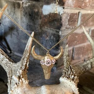 Gold colored cow skull with pink roses necklace.